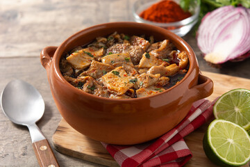 Traditional mondongo or el menudo soup on wooden table