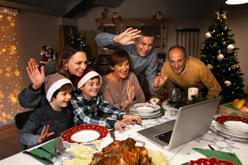 Happy and Excited family greeting their family and friends on Christmas eve using a skype video...