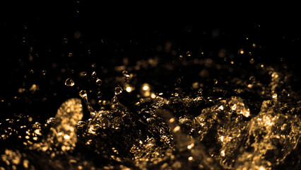 Hi speed close up images of oil liquid from diesel gasoline splashing and moving up to the air on black background for represent power of fuel liquid that active and powerful. studio shot premium gold - obrazy, fototapety, plakaty