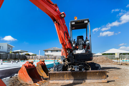 Big red digger, scraper at a new construction development site