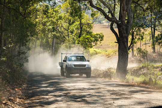 Ute approaching on dusty gravel country road