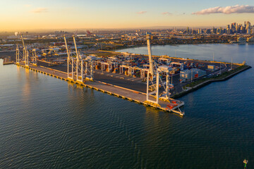 Aerial view of large gantry cranes sitting on the side of a loading dock