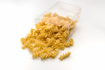Fusilli macaroni Italian dry raw pasta bronze drawn, rough paste from Gragnano,Naples,Italy, in transparent packaging on white background