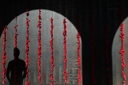 ANZAC DAY at the Australian War Memorial shadow of a man looking at the wall
