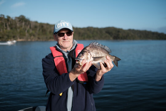 Man holding a Southern Black Bream he Caught