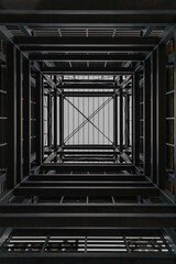 Fototapeta premium Upward view inside metal tower construction