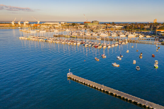 Aerial view a bay side yacht club with long jettys out over the water