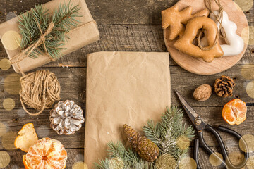 New Year's composition. Gingerbreads, gift wrapped in paper and Christmas decorations on a wooden background. Christmas, winter, new year concept. Flat lay, top view