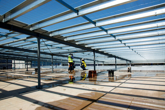 Metal framework and workers on an industrial building site