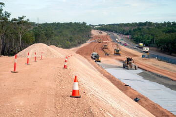 View of workers and heavy machinery on a road construction worksite