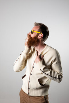 Funky man posing for photographs, wearing a beige shirt