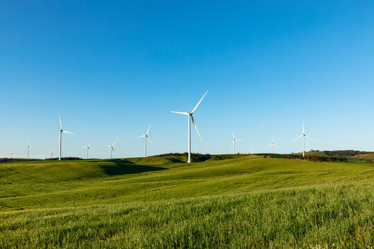 wind turbines on hills in farmland