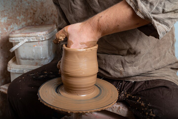 Creating a pot of clay close-up. Hands making products from clay. Potter at work.