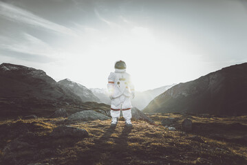 Astronaut exploring a new planet. Searching for a new home for humanity. Concept about science and...