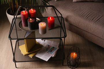 Beautiful aroma candles on table in dark room
