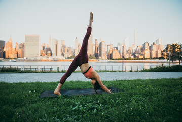 Beautiful girl making morning yoga training in New york
