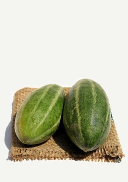 Closeup of Pointed Gourd or Parval Isolated on White Background in Vertical Orientation, Also Known as Green Potato or Trichosanthes Dioica
