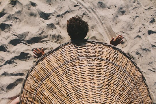Fun photo of person under beach umbrella, as a turtle