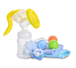 Breast pump with baby items on white background