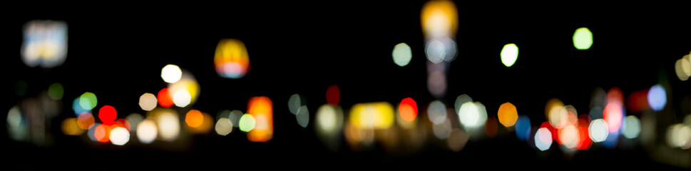 Blurred lights of shops on a city avenue. bokeh. night city.