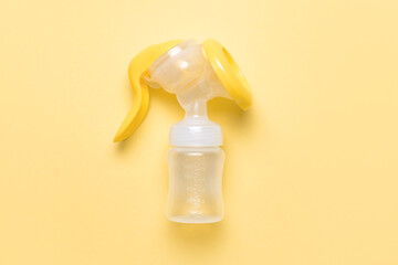 Breast pump on color background