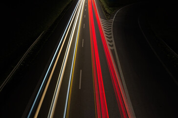 Fototapeta na wymiar Top view of vehicle car light trails on highway road in red and white color. Trafic at night, long exposure