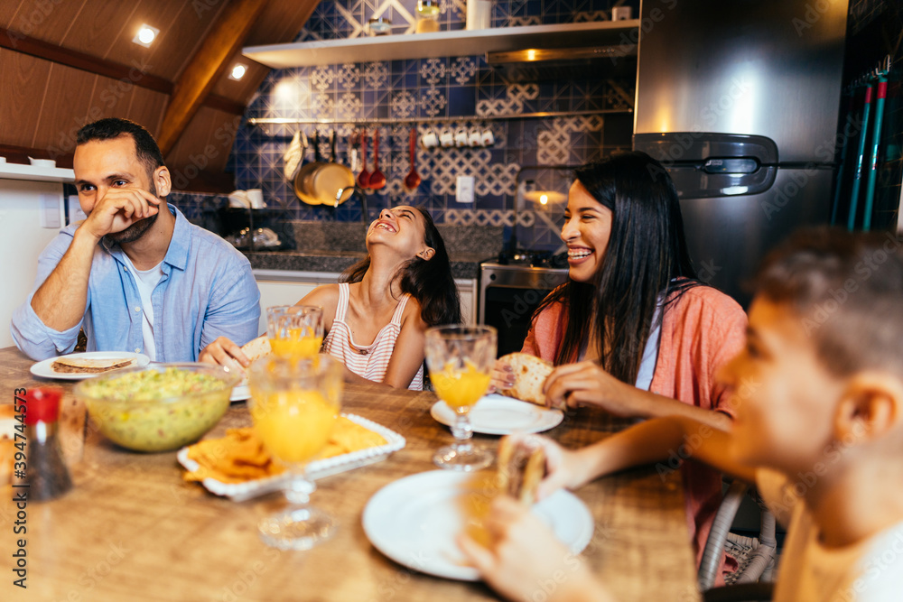 Wall mural latin family having dinner at home