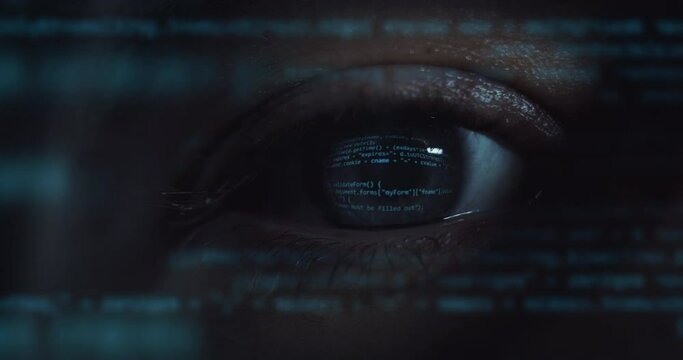 Cinematic macro of young programer's blu eye with latest innovative sophisticated technology display application with augmented reality holograms for realization of new codeproject.