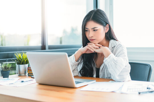 Asian Business woman at home office working using computer laptop technology, small startup business owner entrepreneur, feeling stress anxious impatient noxious from successful business strategy