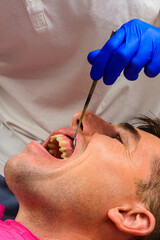 Visiting the dentist, the dentist evaluates the oral cavity and identifies problem areas of the teeth. Fistula mouth 2021