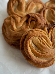 Homemade sweet bun with cinnamon and sugar on white paper background