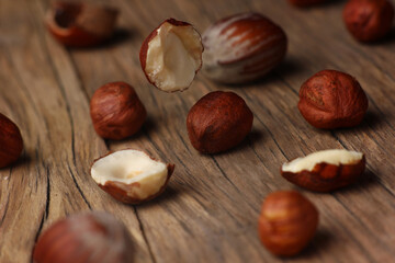 hazelnuts falling on a structural table made of cracked wood