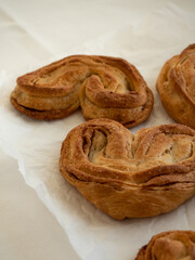 Homemade sweet bun with cinnamon and sugar on white paper background