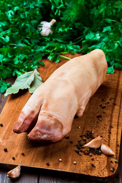 Raw beef hooves for the traditional seasonal dish of khash soup. A dish of boiled cow legs, khash, a dish of the Middle east, Turkey and the Caucasus Close-up, wooden dark background