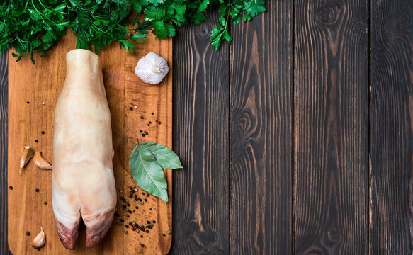 Raw beef hooves for the traditional seasonal dish of khash soup. A dish of boiled cow legs, khash, a dish of the middle east, Turkey and the Caucasus Top view, wooden dark background with copy space