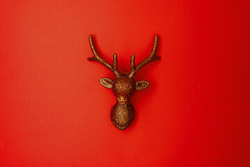 flat lay with christmas reindeer on red background