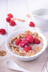 breakfast with brown rice flakes, milk and fresh raspberries