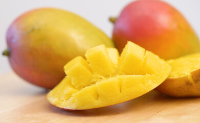 Naklejka na ściany i meble group of delicious mango tropical fruit on wood board