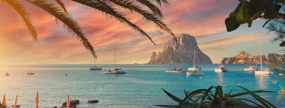 Cala d'Hort beach at sunset. Ibiza Island - Powered by Adobe