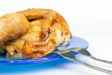 part of fried chicken on a ceramic dish close-up