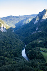 Fototapeta na wymiar Montenegro. Picturesque canyon of the Tara river.Mountains surrounding the canyon.Forests on the slopes of the mountains.