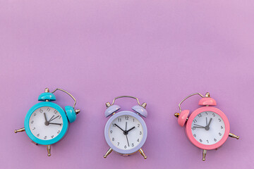 Simply minimal design three ringing twin bell classic alarm clock Isolated on purple violet...