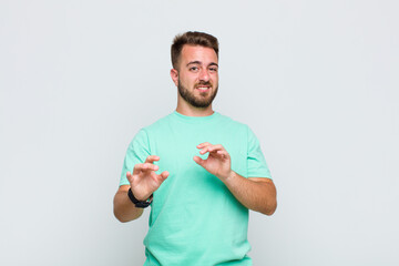 young man feeling disgusted and nauseous, backing away from something nasty, smelly or stinky,...