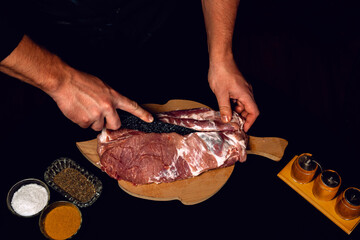 The butcher cuts the pork, marinates the raw meat and cook the kebab.
