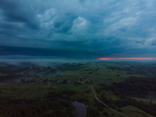 View of the northern Russian village. The fog descends on houses