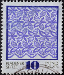 GERMANY, DDR - CIRCA 1974 : a postage stamp from Germany, GDR showing a blue pattern in Plauen lace