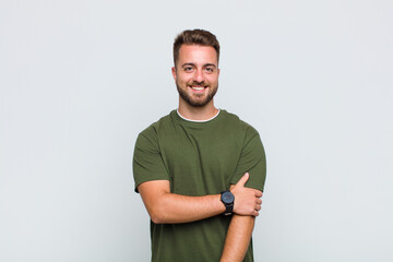 young man laughing shyly and cheerfully, with a friendly and positive but insecure attitude