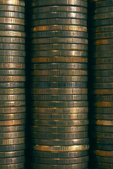 Background or wall from piles and edges of yellow brass coins close-up. 10 ten Russian rubles. Dark textured backdrop or wallpaper for economic, banking, financial, monetary topics. Macro