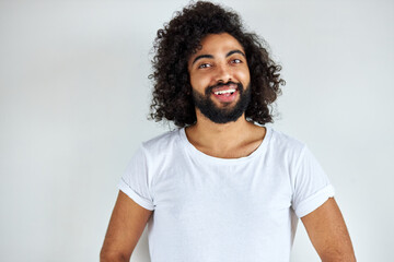 pleasant indian arabian male in shirt looking at camera, has friendly look, open-minded guy isolated over white background