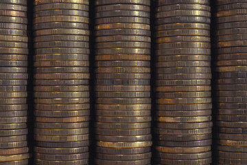 Background or wall from piles and edges of yellow brass coins close-up. 10 ten Russian rubles. Dark textured backdrop or wallpaper for economic, banking, financial, monetary topics. Macro